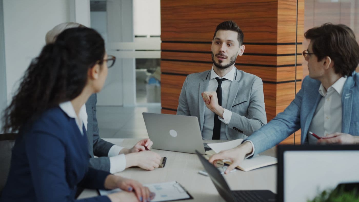 A Aurum Capital Investment team meeting in a modern office